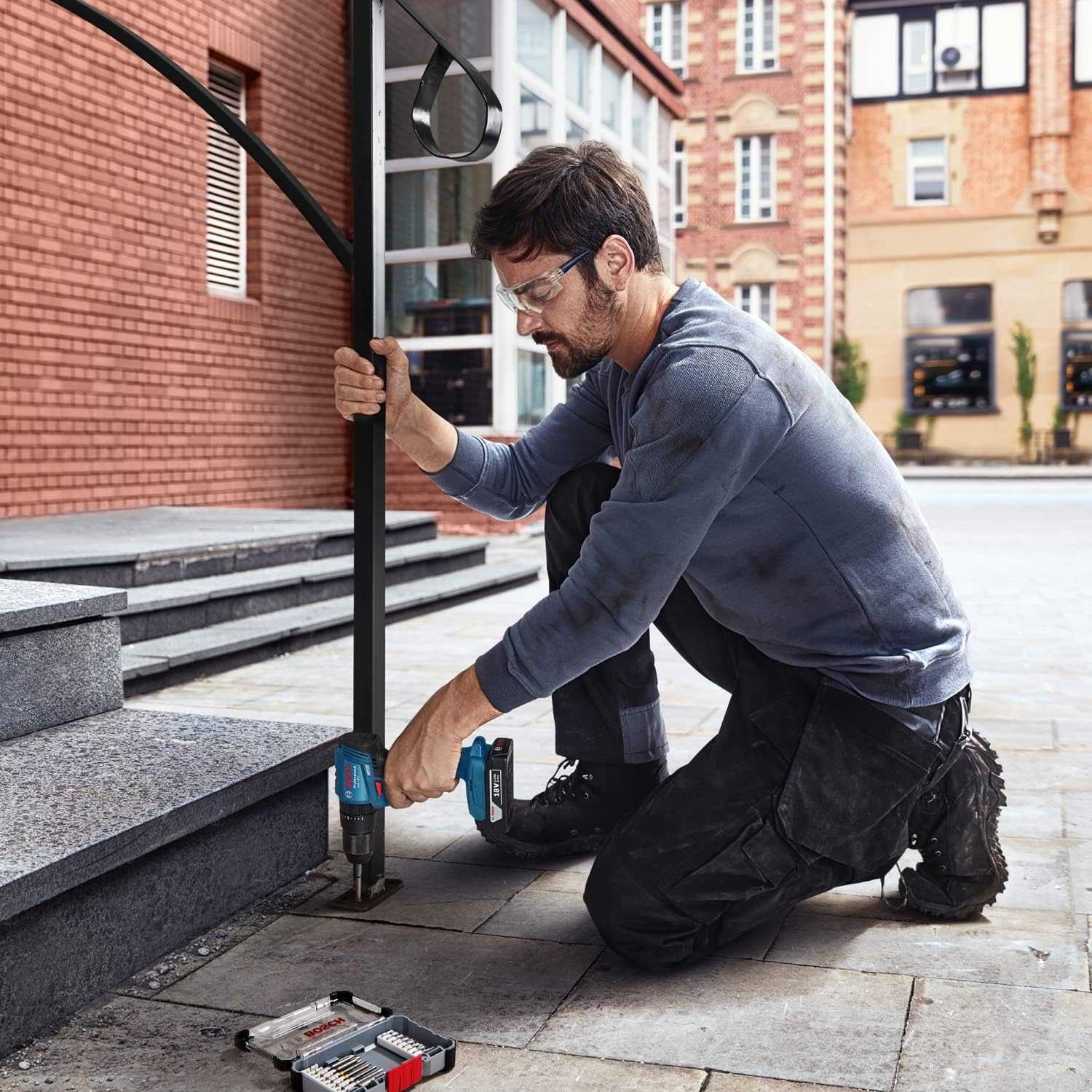 Bosch Professional GSB 185-LI 18V Impact Drill (2x2.0 Ah, GAL 18V-20, 23 pcs Accessories) - Deluxe Electricals