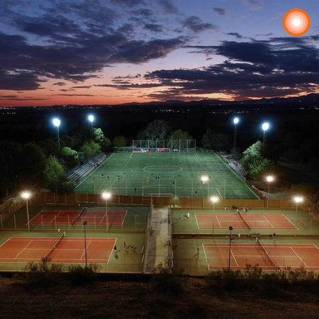 Ledvance LED Eco Lite Floodlight 100W G2 IP65 mounted on tall towers lighting a sports complex at dusk UAE